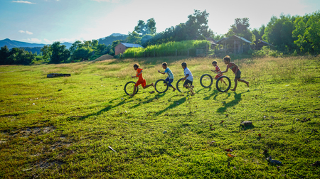 Daklak, Vietnam - Oct 10, 2015. Children playing on field at summer day in Daklak, Central Highlands of Vietnam.のeditorial素材