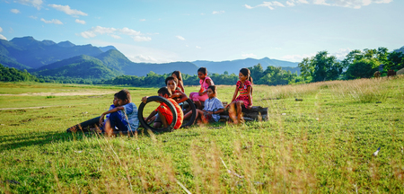 Daklak, Vietnam - Oct 10, 2015. Children sitting on the field at summer day in Daklak Province, Central Highlands of Vietnam.のeditorial素材