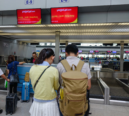 Saigon, Vietnam - Mar 28, 2017. A couple waiting at Vietjet Counters of Tan Son Nhat Airport in Saigon, Vietnam. Tan Son Nhat is the busiest international airport in Vietnam.のeditorial素材