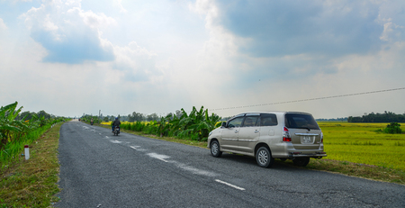 Tien Giang, Vietnam - Aug 31, 2017. A car parking on highway in Tien Giang, Mekong Delta, Vietnam.のeditorial素材