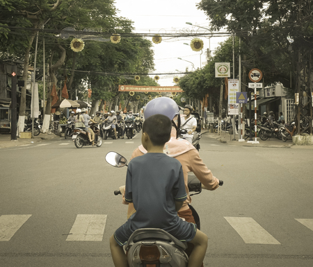 Long Xuyen, Vietnam - Sep 1, 2017. People riding motorbike on busy street in Long Xuyen, Vietnam. Long Xuyen is the provincial city and capital city of An Giang Province.のeditorial素材
