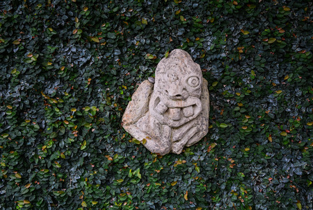 A stone statue for decoration at green garden in Bali, Indonesia.の写真素材