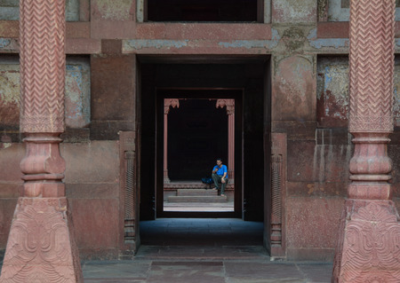Agra, India - Jul 13, 2015. A man sitting at Agra Fort in Agra, India. The fort was main residence of the emperors of the Mughal Dynasty till 1638.のeditorial素材