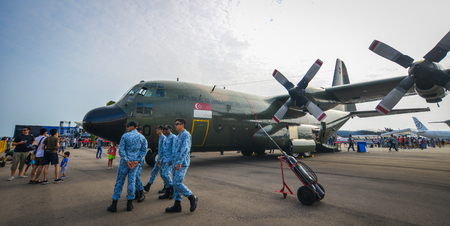 Singapore  - Feb 10, 2018. Soldiers looking at a Lockheed C-130 Hercules aircraft belong to the...