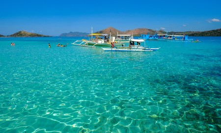Coron, Philippines - Apr 10, 2017. Boats on blue sea in Coron Island, Philippines. Coron is a wedge-shaped limestone island in the province of Palawan.のeditorial素材