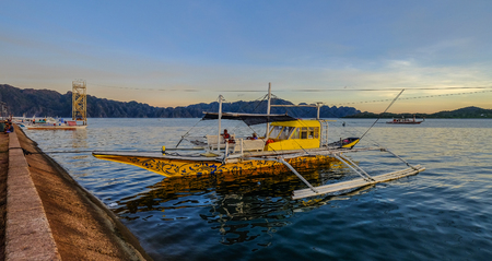 Palawan, Philippines - Apr 6, 2017. A traditional boat docking on sea at sunset in El Nido Island, Palawan, Philippines.のeditorial素材