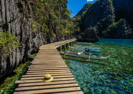 Palawan, Philippines - Apr 11, 2017. Small boats at wooden pier in Palawan, Philippines. Palawan is one of the most beautiful islands in the Asia.の写真素材