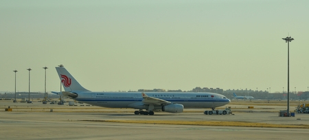 Beijing, China - Mar 1, 2018. An Air China aircraft on runway in sunset at Terminal 3 of Beijing Capital Airport (PEK), China.のeditorial素材