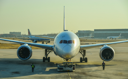 Beijing, China - Mar 1, 2018. A civil aircraft on runway in sunset at Terminal 3 of Beijing Capital Airport (PEK), China.のeditorial素材