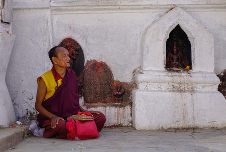 Kathmandu, Nepal - Oct 18, 2017. A monk praying at Swayambhunath Temple in Kathmandu, Nepal. The temple is probably the most sacred among Buddhist pilgrimage sites.のeditorial素材