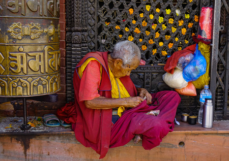 Kathmandu, Nepal - Oct 18, 2017. A monk sitting at Swayambhunath Temple in Kathmandu, Nepal. The temple is probably the most sacred among Buddhist pilgrimage sites.のeditorial素材