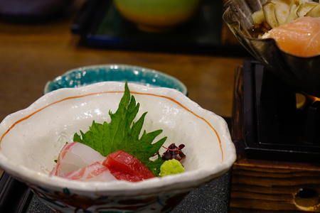 Mixed sliced fish sashimi in bowl. Sashimi is a Japanese delicacy consisting of very fresh raw meat or fish sliced.の写真素材