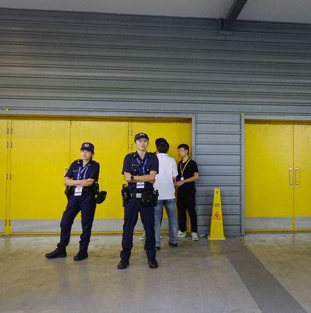Singapore - Feb 11, 2018. Police men working at bus station to Changi Airbase in Singapore.のeditorial素材