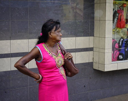 Port Louis, Mauritius - Jan 4, 2017. A woman standing and waiting at bus station in Port Louis, Mauritius.のeditorial素材