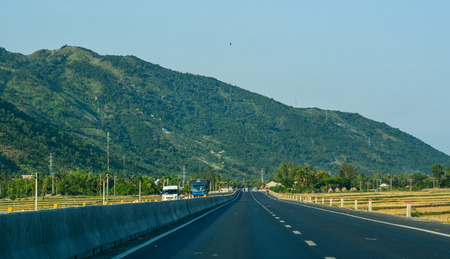Nha Trang, Vietnam - Mar 21, 2016. Cars run on National Route 1A in Nha Trang, Vietnam. The total length of the Viet Nam road system is about 222,179 km.のeditorial素材