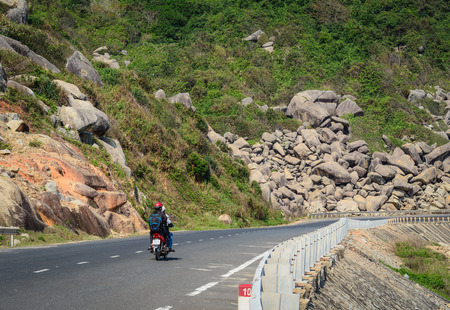 Nha Trang, Vietnam - Mar 21, 2016. A motorbike running on National Route 1A in Nha Trang, Vietnam. The total length of the Viet Nam road system is about 222,179 km.のeditorial素材