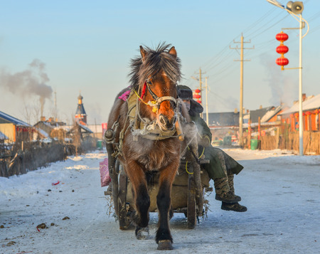 Heilongjiang, China - Feb 19, 2018. Horse cart running at snow village in Mohe County, Heilongjiang, China.のeditorial素材