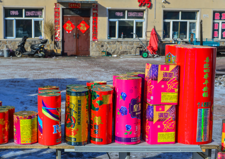 Mohe, China - Feb 19, 2017. Stack of red firecrackers for sale at local market in Mohe County, Heilongjiang, China.のeditorial素材