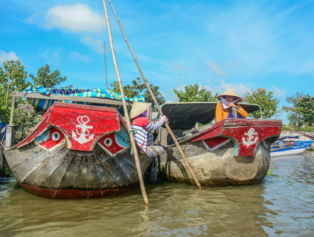 Mekong Delta, Vietnam - Feb 2, 2016. Cargo wooden boats at floating market on Mekong River in Mekong Delta, Vietnam.のeditorial素材