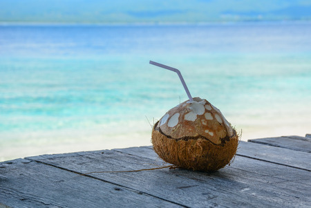 Drinking coconut at summer day on Lombok Island, Indonesia.