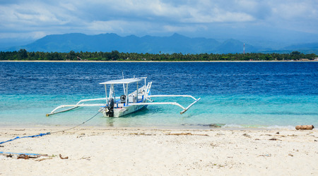 Lombok, Indonesia - Apr 17, 2016. A traditional boat waiting on the beach in Lombok, Indonesia.のeditorial素材