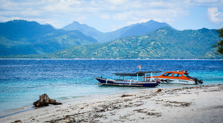 Bali, Indonesia - Apr 17, 2016. Tourist boats waiting on sand beach at summer day in Bali Island, Indonesia.のeditorial素材