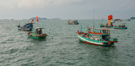 Wooden boats with national flags docking on Nam Du Island, Vietnam.の写真素材