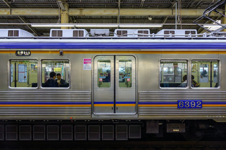 Osaka, Japan - Nov 24, 2016. A train stopping at a JR Railway Station. The railway system in Japan has a high reputation for punctuality and safety.のeditorial素材