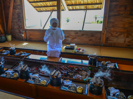 Matsusaka, Japan - Mar 18, 2018. Woman serving seafood at a traditional restaurant near Ise Bay in Matsusaka, Japan.のeditorial素材