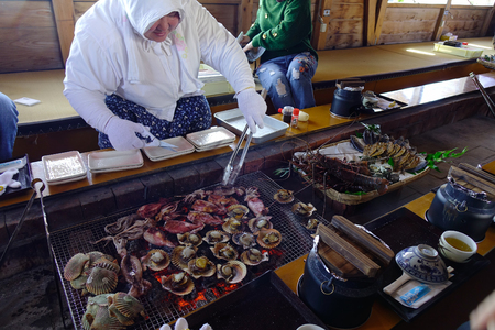 Matsusaka, Japan - Mar 18, 2018. Woman serving seafood at a traditional restaurant near Ise Bay in Matsusaka, Japan.のeditorial素材