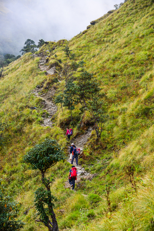 Khopra, Nepal - Oct 22, 2017. Young travelers with backpack walking on trail of Annapurna Circuit Trekking in Khopra, Nepal.のeditorial素材