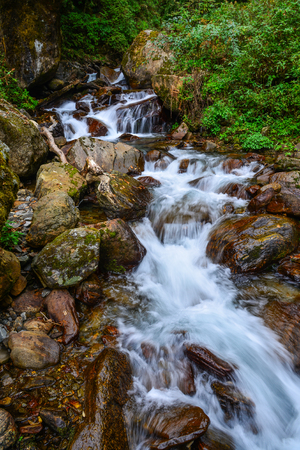 Small waterfall with stream at deep forest in Khopra, Nepal.の写真素材