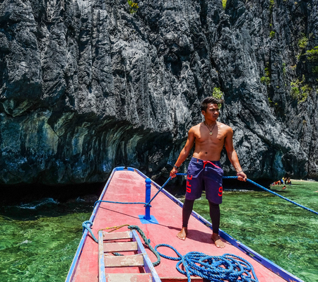 Palawan, Philippines - Apr 5, 2017. A man standing on tourist boat in Palawan, Philippines. Palawan is the island of idyllic tropical beauty.のeditorial素材
