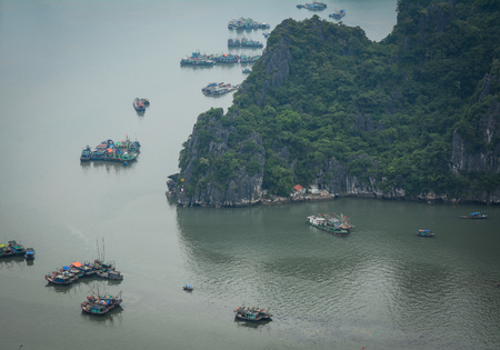 Boats on the sea at misty day in Ha Long, Vietnam. Ha Long Bay is a UNESCO Site and popular travel destination.の写真素材