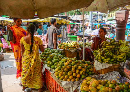 Bodhgaya, India - July 9, 2015. Vendors selling fresh fruits at local market in Bodhgaya, India.のeditorial素材