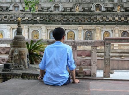 An Asian man practicing yoga meditation at a monastery.の写真素材