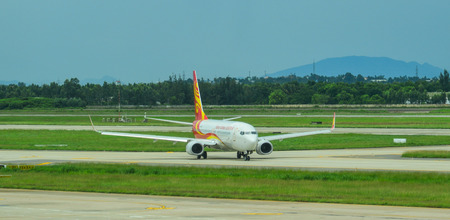 Da Nang, Vietnam - Jul 23, 2018. A Boeing 737-800 airplane of Hainan Airlines taxiing on runway of...