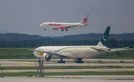 Kuala Lumpur, Malaysia - May 4, 2018. Passenger airplanes taxiing on runway at Kuala Lumpur...