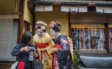 Kyoto, Japan - Nov 20, 2016. Geisha wearing traditional dress (kimono) walking on street in Kyoto, Japan. Geisha are traditional female Japanese entertainers.のeditorial素材