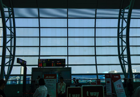 Jeju, South Korea - Sep 21, 2016. Airplane taking off, view from Boarding Gate of Jeju International Airport (CJU).のeditorial素材