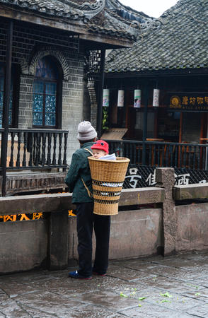 Hunan, China - Nov 5, 2015. Vendors walking on street at Fenghuang Ancient Town in Hunan, China.のeditorial素材