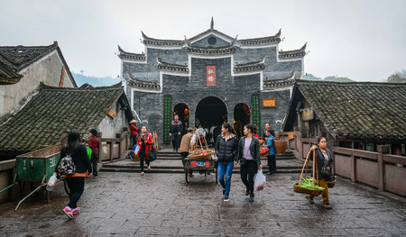 Hunan, China - Nov 5, 2015. Vendors walking on street at Fenghuang Ancient Town in Hunan, China.