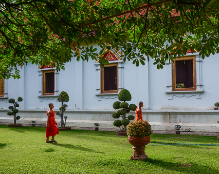 Chiang Mai, Thailand - Jun 22, 2016. Novice monks walking at an ancient Buddhist temple in Chiang Mai, Thailand.のeditorial素材