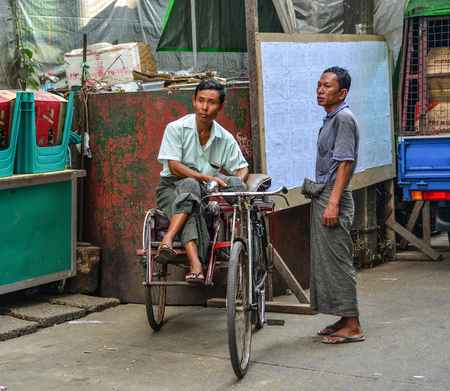 Yangon, Myanmar - Feb 1, 2017. Pedicab driver on street in Yangon, Myanmar. Yangon is Myanmar...