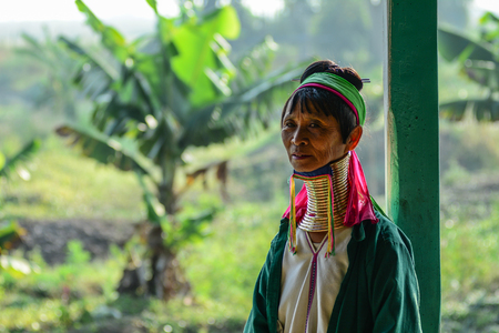 Inle Lake, Myanmar - Feb 7, 2016. A Kayan woman (Long Neck People) weaving silk fabric on a wooden loom in Inle Lake, Myanmar.のeditorial素材