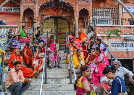 Jaipur, India - Nov 1, 2017. Indian people in colorful traditional dress sitting on street at Pink...