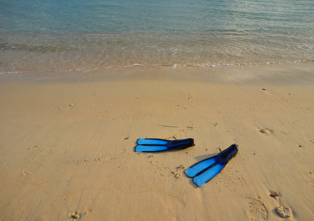 Snorkeling or Scuba diving fins on beach in summer day.の写真素材