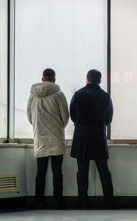Harbin, China - Feb 28, 2018. Passengers standing at waiting room of Harbin Taiping International Airport in a snowing winter day.のeditorial素材