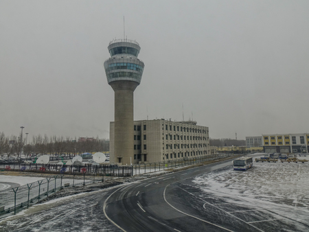 Harbin, China - Feb 28, 2018. Harbin Taiping International Airport in a snowing winter day. Taiping is the largest northernmost airport of China.のeditorial素材