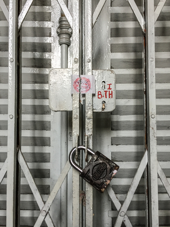 Saigon, Vietnam - Sep 5, 2018. Old steel door with lock at ancient town in Saigon, Vietnam. Saigon (called Ho Chi Minh) is the biggest city in Vietnam.のeditorial素材